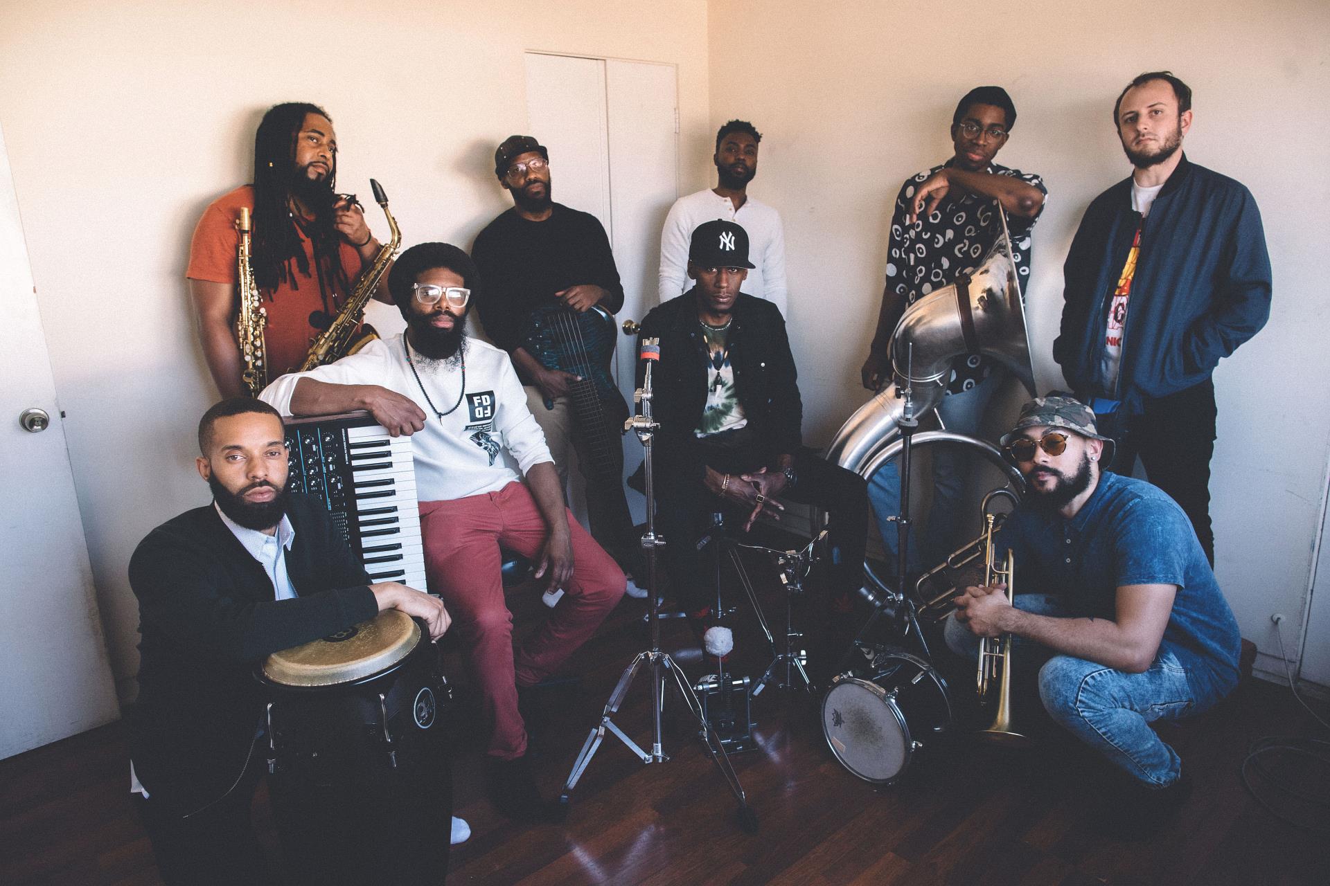 Diverse musicians posing together indoors.